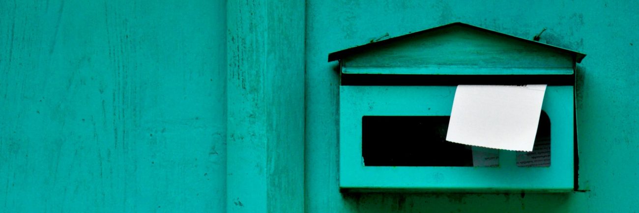 green mailbox at old wood door